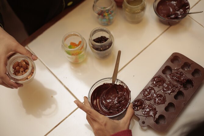 Bean-to-Bar Chocolate Workshop in ChocoMuseo Lima Miraflores - Grinding cacao nibs with a melangeur