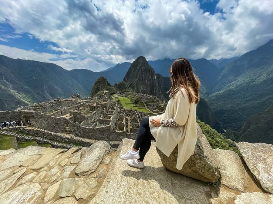 A traveller on the terraces above the ruins of Machu Picchu