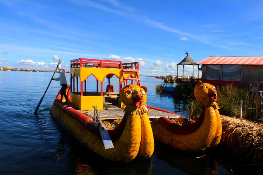 From Puno: Uros floating islands half Day tour - Arriving on a floating island