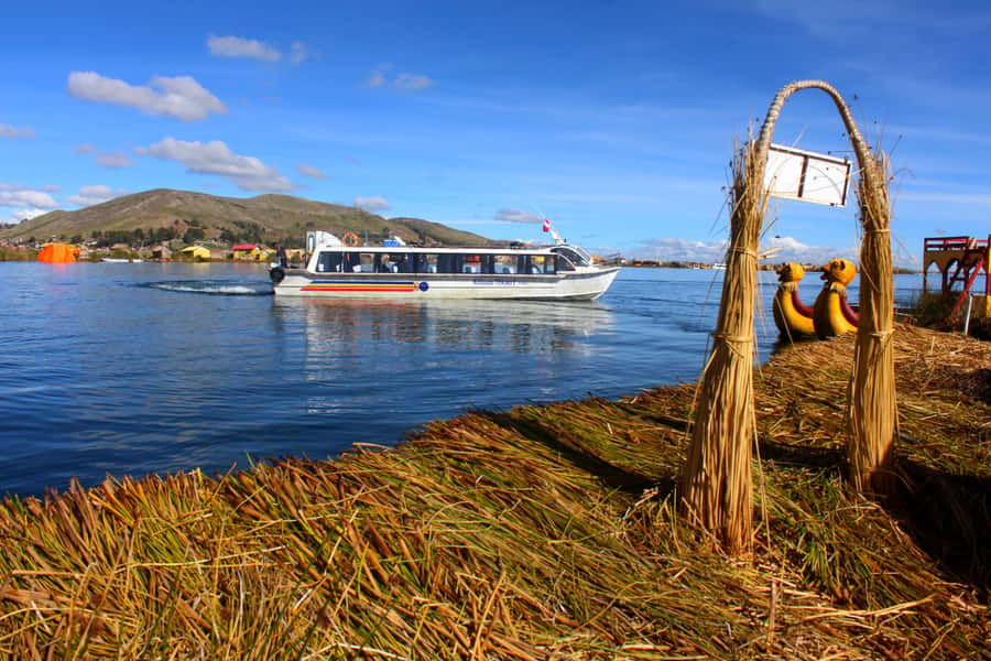 From Puno: Uros floating islands half Day tour - The handmade boat ride and the main catch